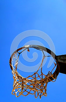 Basket with ruined net seen from below in the morning sun