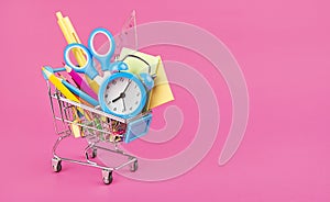 Basket with school supplies on a pink background. Back to school concept. Purchase of school supplies. Baner. Copy space