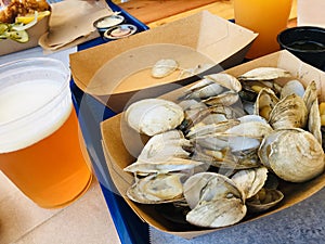 basket of steamers clams and glass of beer