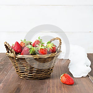 Basket of strawberry on wooden table with white background