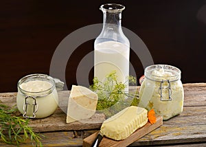 Basket with tasty organic dairy products on wooden table,