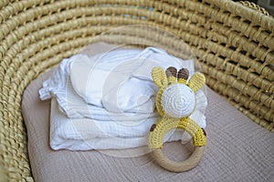basket there are things for the baby and wooden and knitted toys-rattles. Natural natural minimalistic style. View from