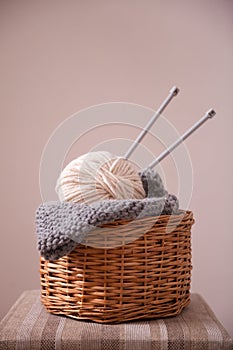 Basket witn yarn clew and knitting needles