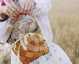Basket in the women's hands with bread