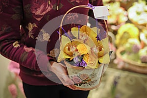 Basket with yellow orchid flowers.