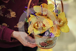 Basket with yellow orchid flowers.