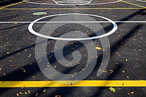 Basketball area in circle on the marking playing field with asphalt tarmac.