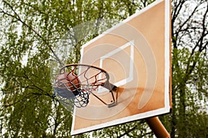 Basketball backboard and the ball hits exactly in the ring, a symbol of a yard street game