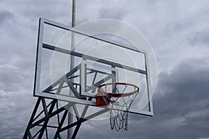 Basketball backboard with a ring, color photo processing. Black and white photo and ring highlighted in red. Focus on