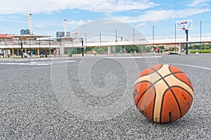 Basketball ball on asphalt ground