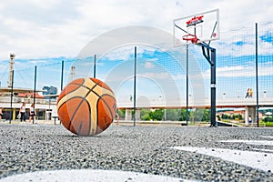 Basketball ball on asphalt ground