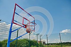 A basketball ball in the basket. Scoring a goal on a summer sports ground during a basketball game