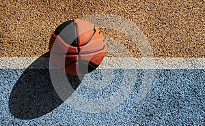 Basketball ball in a colorful street basketball court. Copy space