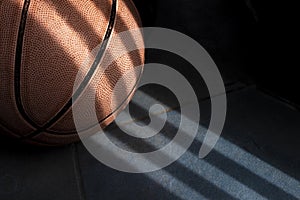 Basketball ball on a dark blue floor. Shadow drawing.