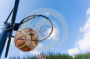 Basketball ball enters the basket in a swish shoot