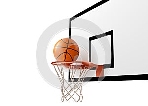 Basketball ball falling into ring net at backboard photo
