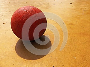 A basketball ball is placed on a basketball court