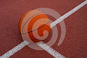 Basketball ball placed on urban street (outdoor) basketball court