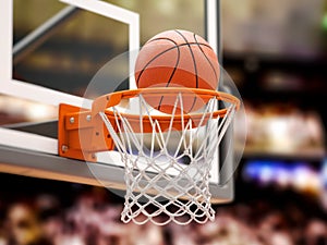 Basketball ball scoring the winning  points on basketball net hoop on basketball arena
