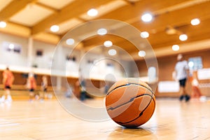 Basketball Ball on Wooden Court. Basketball Game in the Blurred Background. Basketball Court Background