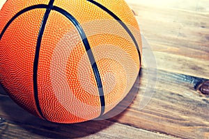 Basketball ball on wooden hardwood floor.