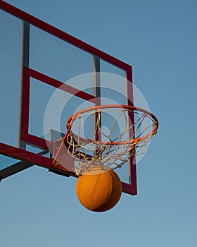 Basketball. The basketball ball hit the basket. This is a win.