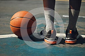 Basketball, basketball player and athlete legs close up on basketball court outdoors fitness training workout. Young