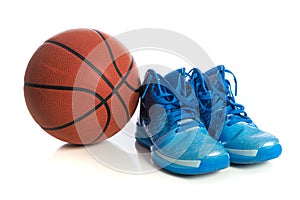 Basketball with blue basketball shoes on white
