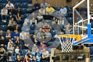 Basketball board and basket with fans in the background. Basketball basket in the background of the audience