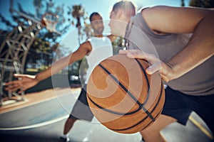 Basketball, competitive sports and practice match with men, players or friends playing a game at an outdoor court