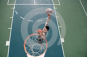 Basketball concept. Man jumping and making a slam dunk playing streetball, basketball. Urban authentic.