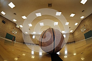 Basketball on Court with Hoops Rim Hardwood Floor Lights