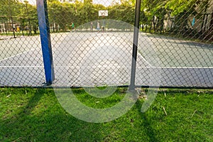 A basketball court with metal fence sihouette
