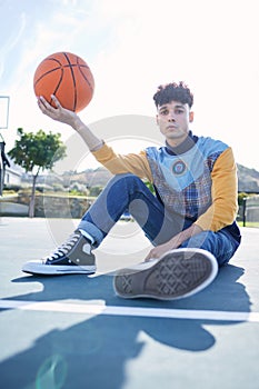 Basketball, court and portrait of a man model sitting on the ground with stylish, trendy and cool clothes. Sports, relax
