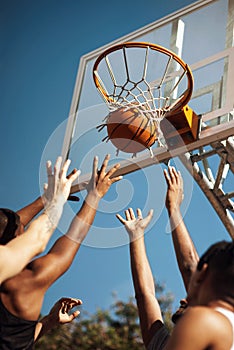 Basketball is a fast-moving game. Closeup shot of a group of sporty young men playing basketball on a sports court.