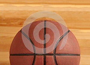 Basketball on floor of hard wood court