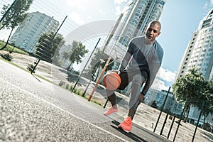 Happy active man playing on the basketball court photo