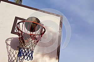 Basketball game outdoor equipment. Basket and ball. Accurate ball throw in basket.