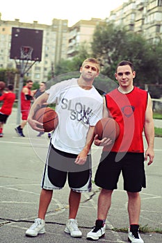 Basketball game on the street. Basketball players pose for the camera.