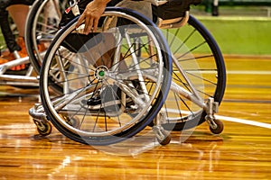 Basketball game on wheels with emphasis on the wheel of a chair