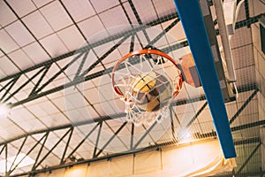 Basketball going through the basket at a sports arena