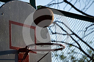 Basketball going through the basket at a sports arena intentional spotlight