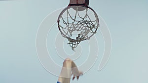 Basketball going through outdoor basketball hoop