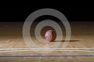 Basketball on hardwood court floor with lighting. Workout online concept. Horizontal sport theme poster, greeting cards, headers,