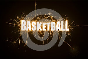 Basketball headline title in sparks on dark background.