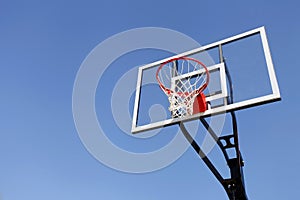 Basketball Hoop and Backboard against Blue Sky