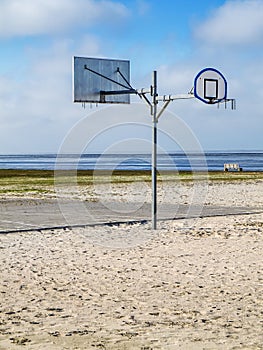 Basketball hoop on the beach vertical