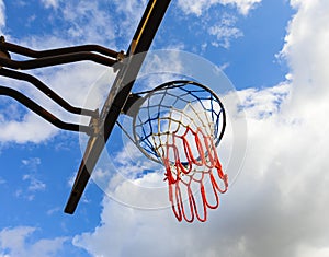 Basketball hoop on a blue sky. Basketball hoop in the public arena. Street photo, nobody, copy space for text