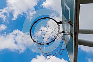 Basketball hoop with blue sky with low angle view