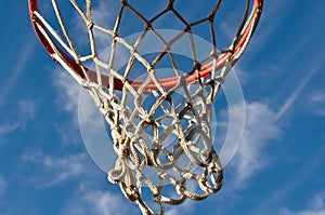 Basketball Hoop with Clouds and Blue Sky